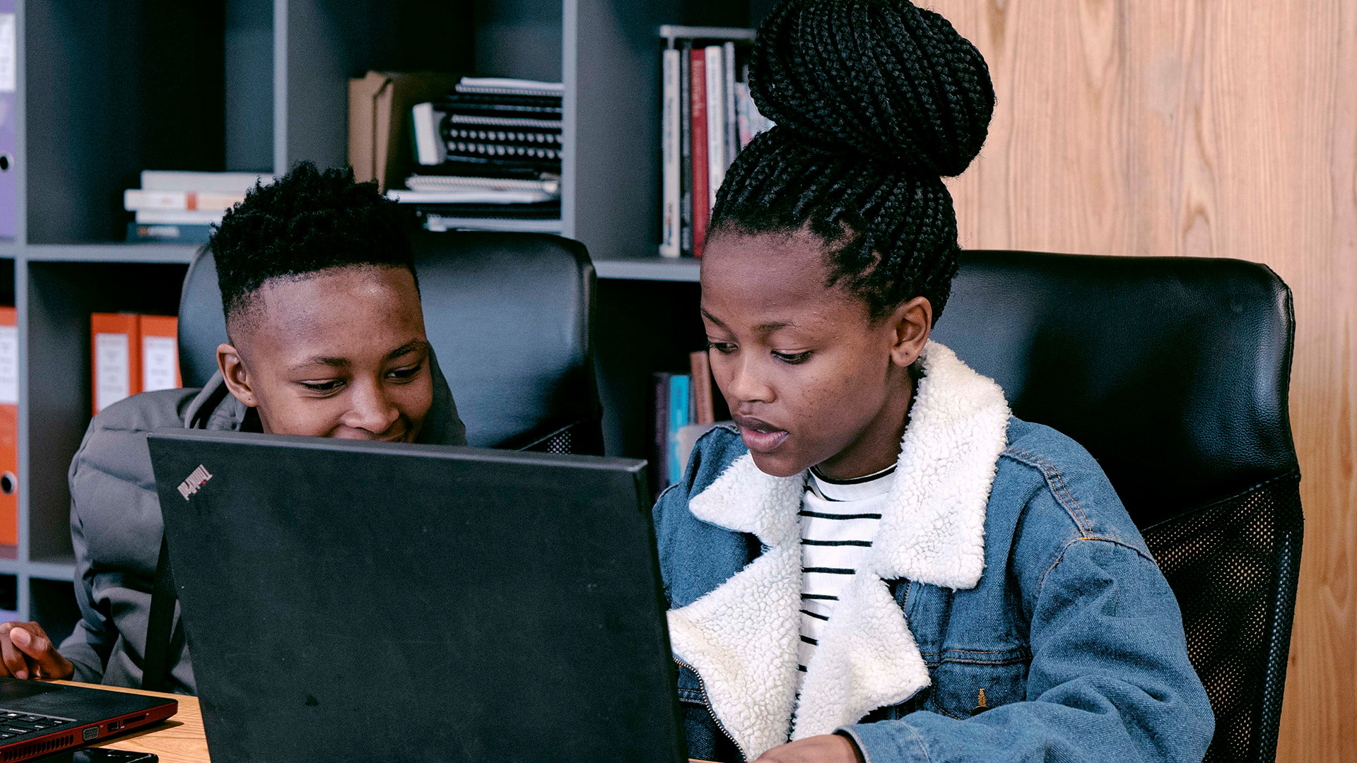 202 Limitless interns looking at a computer