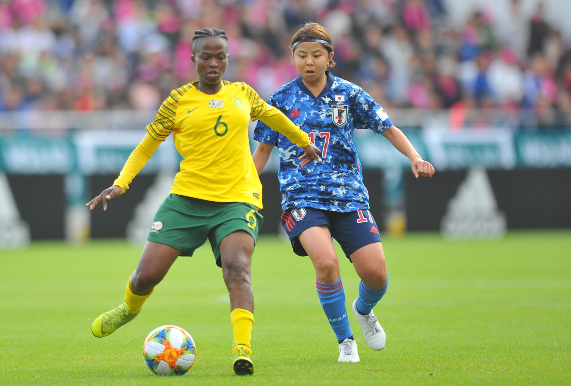 banyana banyana player kicking the ball in the game against japan