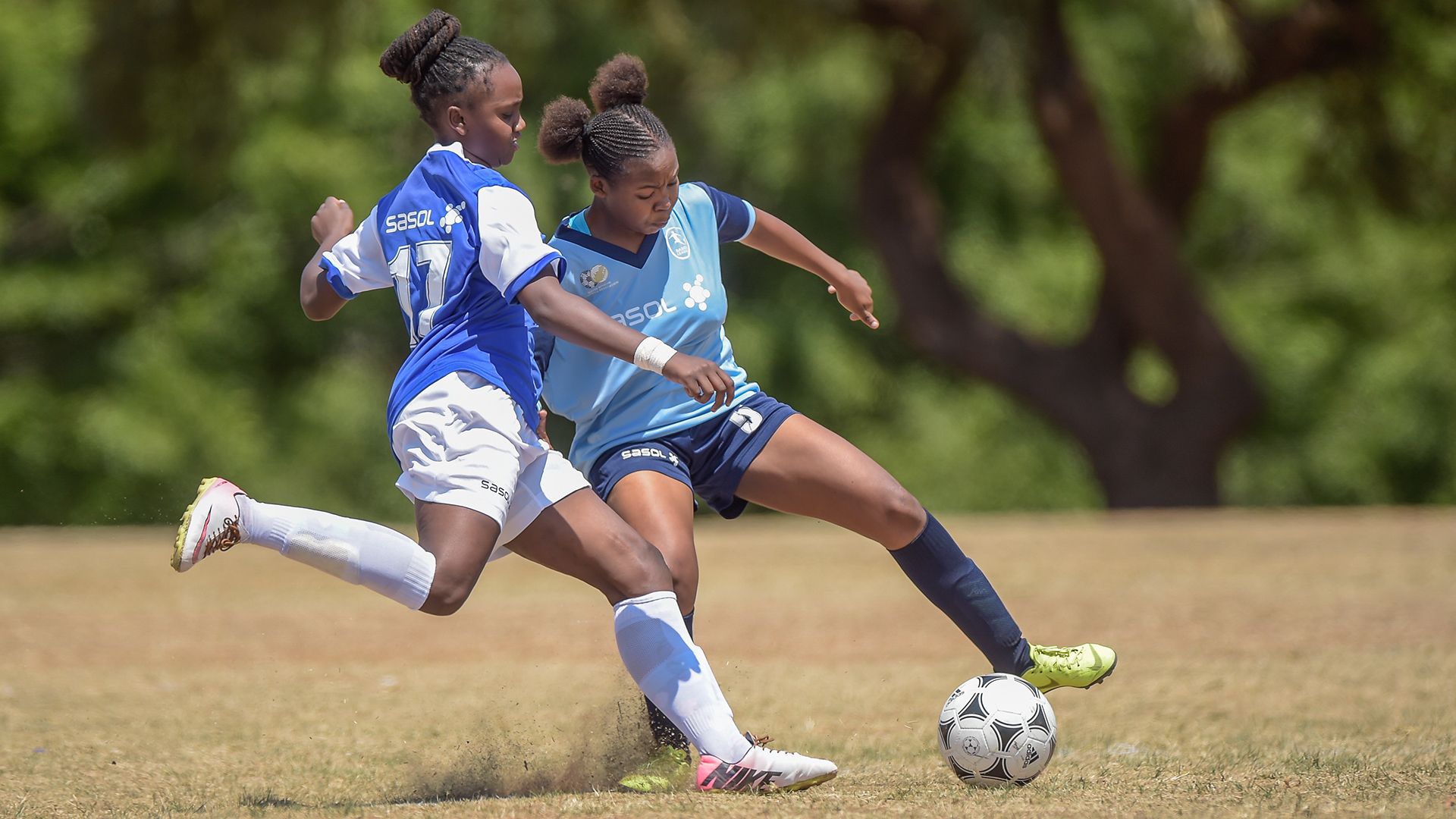 two sasol league players fight for the ball