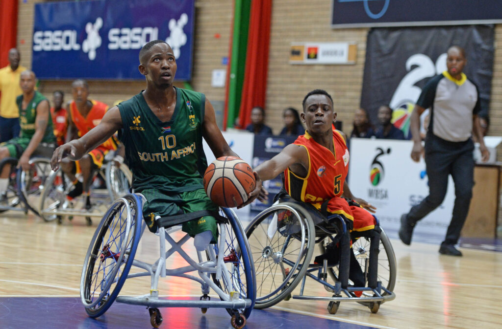 Xola Yalezo of South Africa is challenged by Adilson Joao of Angola during the 2023 African Para Games Senior Mens Qualifier game between Angola and South Africa at Mandeville Sports Complex in Johannesburg